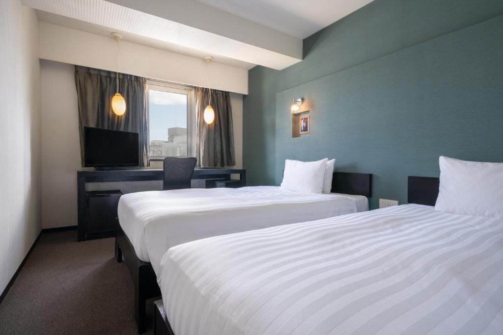 Postel nebo postele na pokoji v ubytování Hotel Vista Atsugi