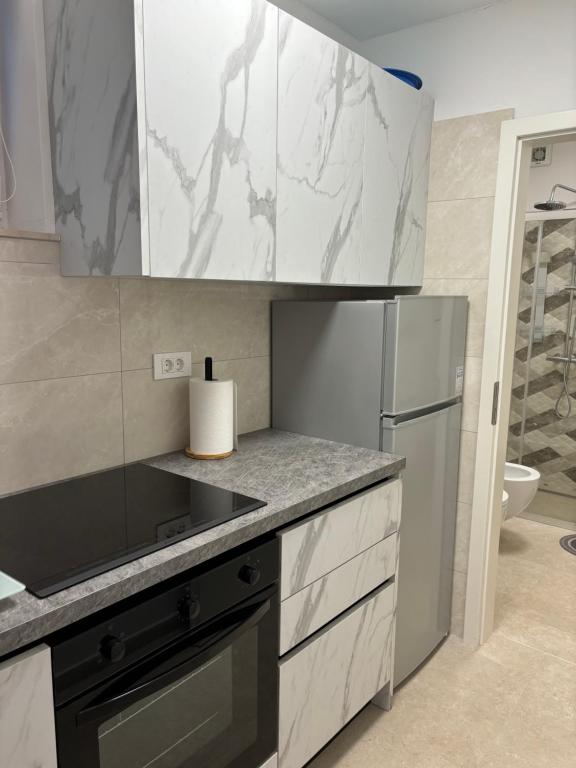 a kitchen with a sink and a refrigerator at Lazar ONE Aparment in Izola