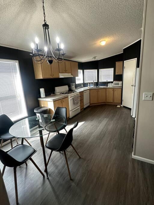 a kitchen with a table and chairs and a dining room at Cute and cozy river house! in Bullhead City