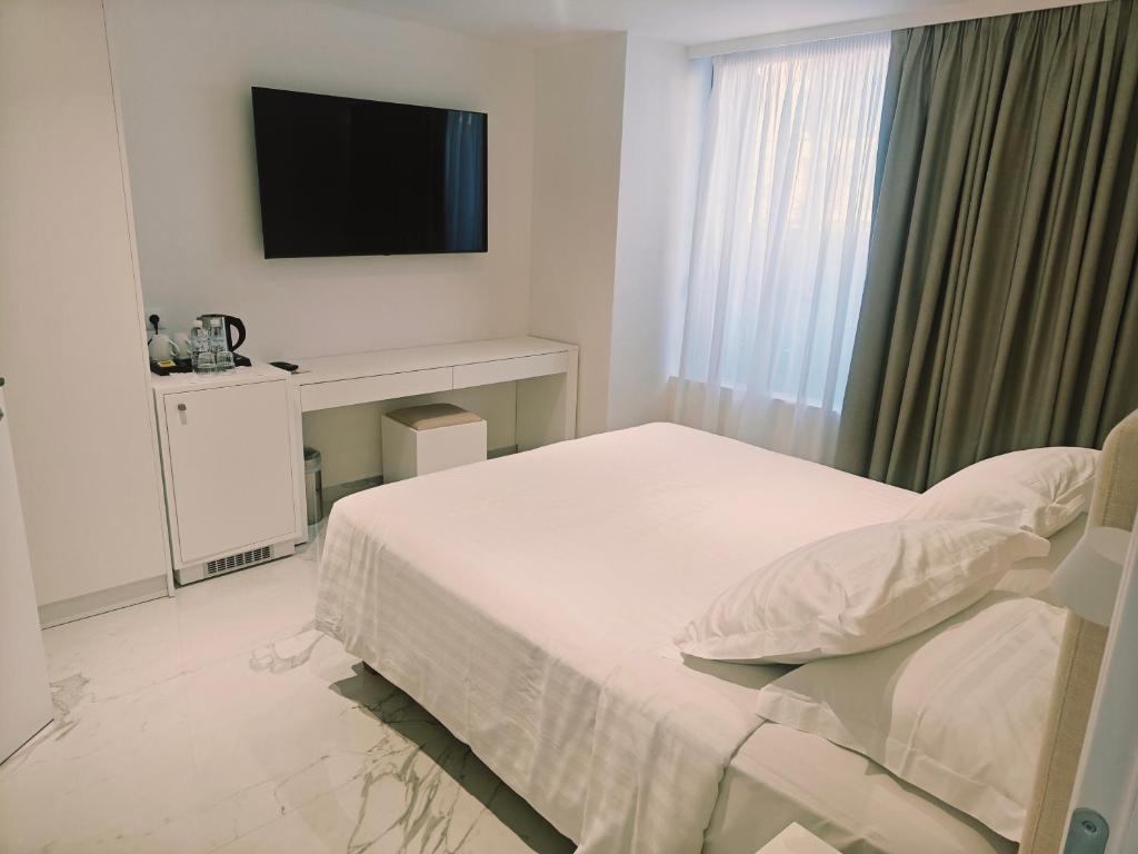 Postel nebo postele na pokoji v ubytování Ibiscus Hotel
