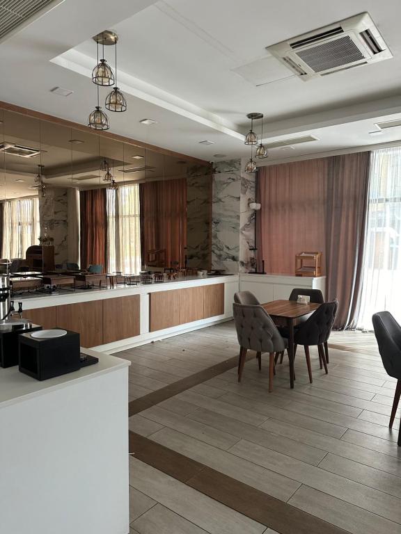 a large room with a table and chairs in it at Aqua Batumi 44 in Batumi