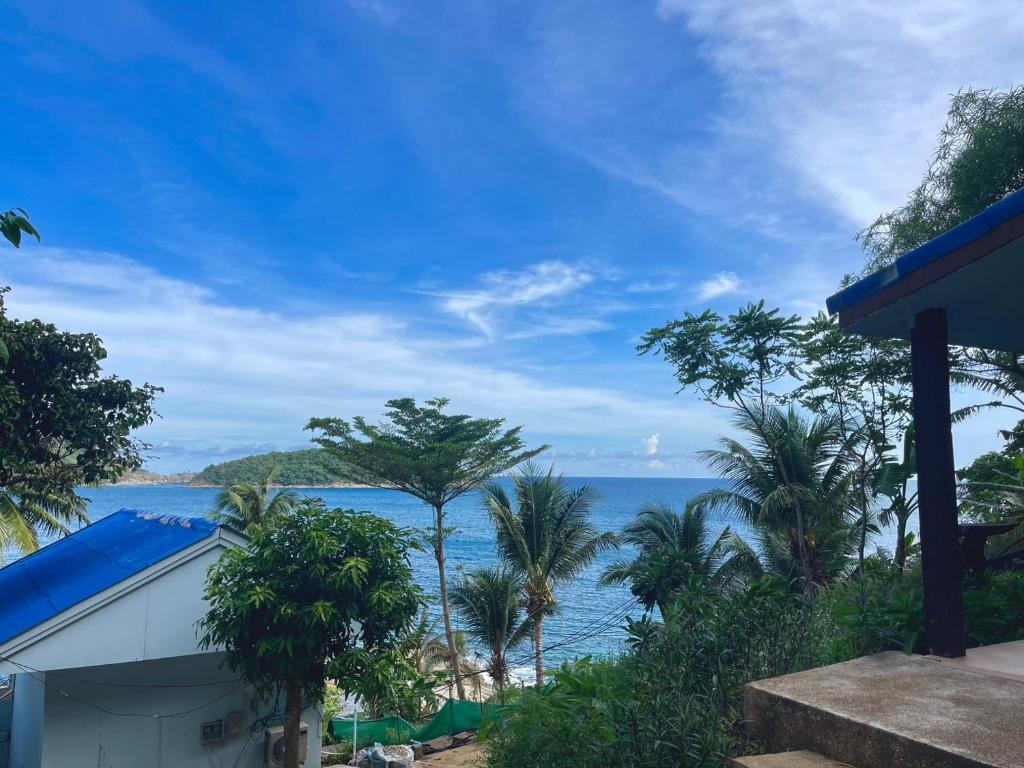 a view of the ocean from a house at Naiharn On The Rock Resort Phuket in Nai Harn Beach