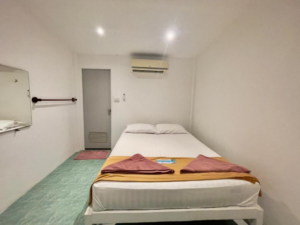 a small bedroom with a bed in a room at Naiharn On The Rock Resort Phuket in Nai Harn Beach