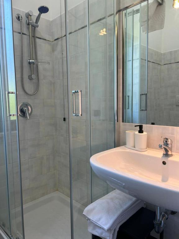 a bathroom with a sink and a shower at La Flacca Rooms in Sperlonga