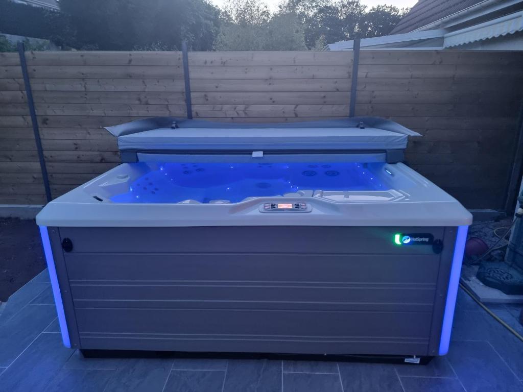 a hot tub sitting on top of a patio at Spassionnement pool in Jouy-le-Moutier