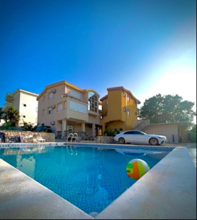 a swimming pool with a ball in front of a house at Casa Calma in Bar
