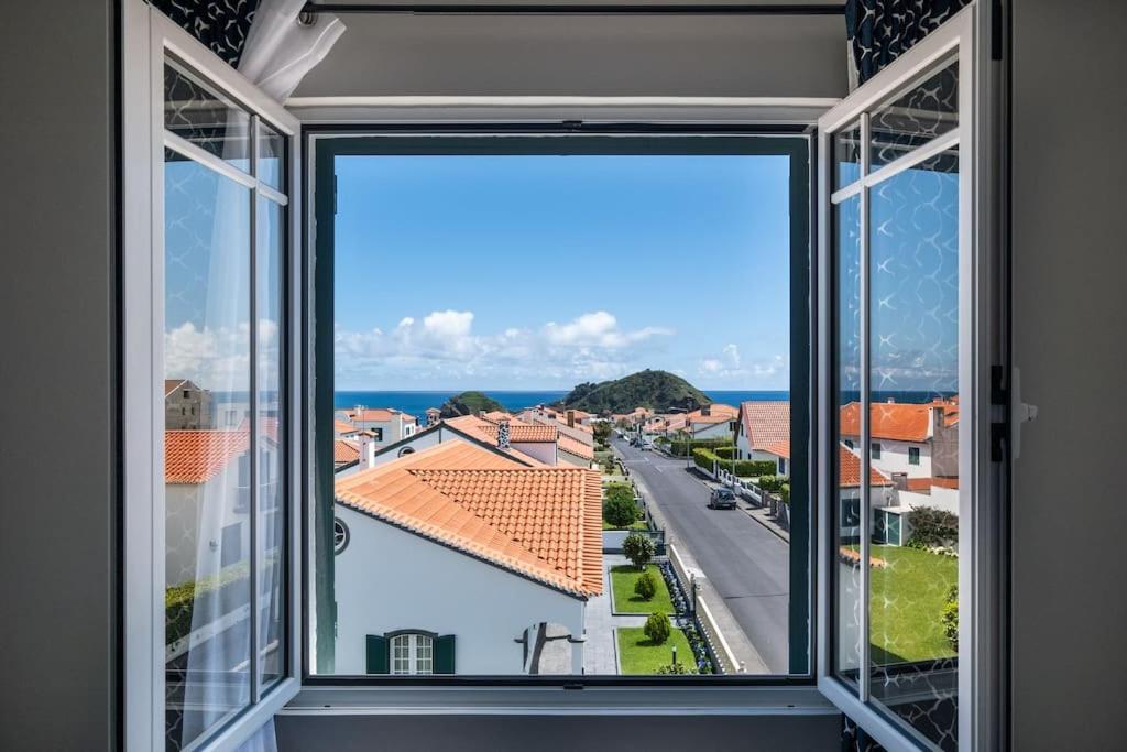 a window with a view of a street at Vistamar Ilhéu in Vila Franca do Campo