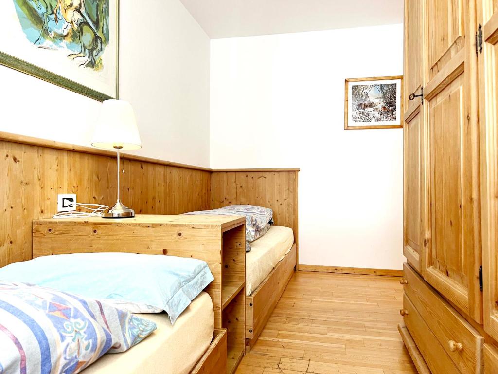 Postel nebo postele na pokoji v ubytování Moena Appartamenti