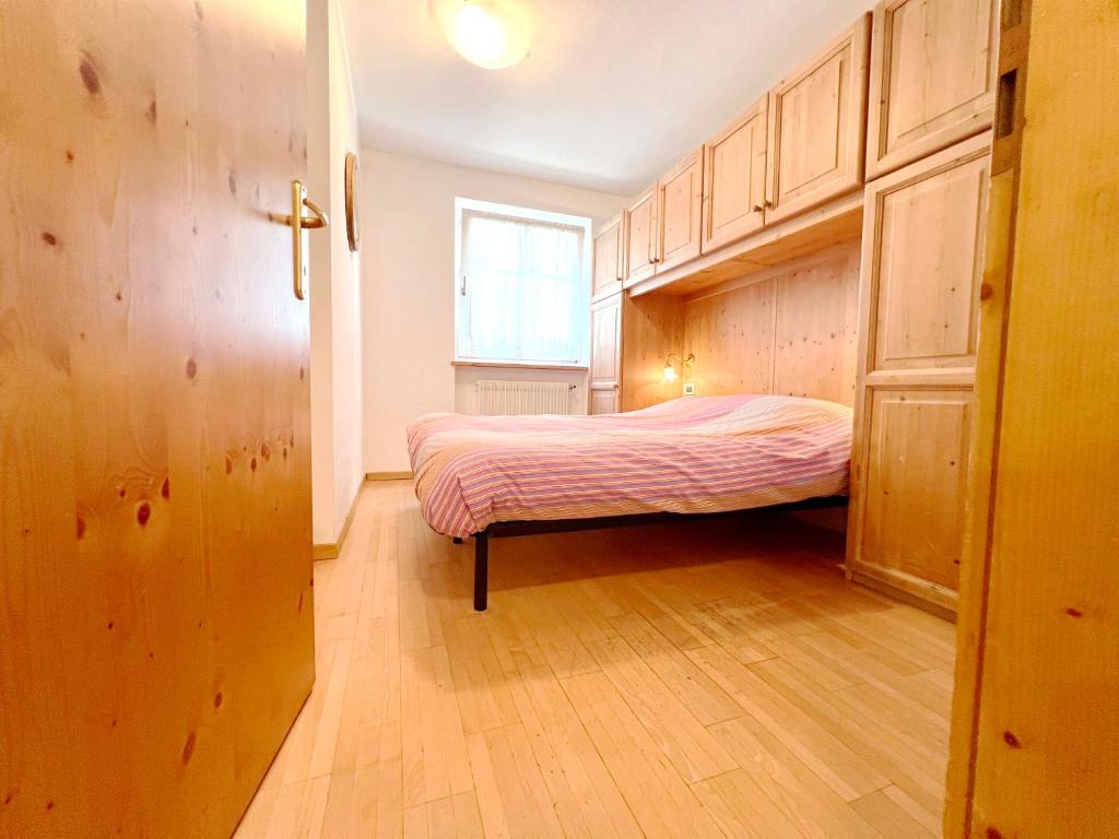 Postel nebo postele na pokoji v ubytování Moena Appartamenti