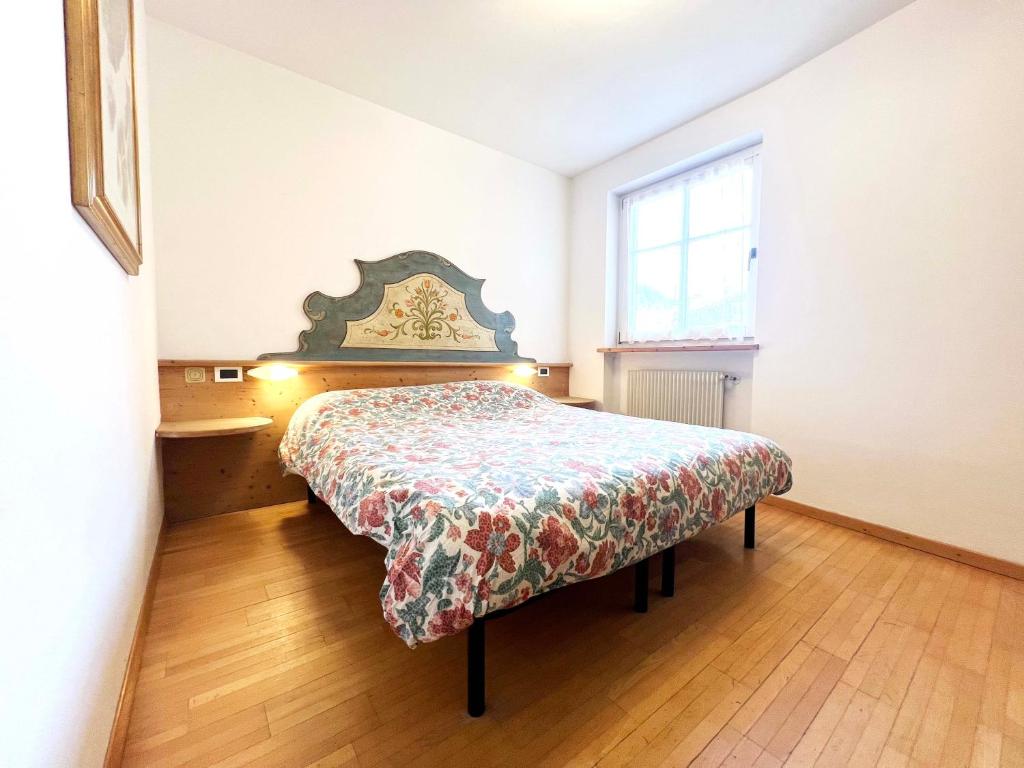 Postel nebo postele na pokoji v ubytování Moena Appartamenti