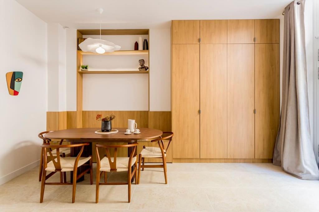 une salle à manger avec une table et des chaises en bois dans l'établissement Un architecte en voyage, à Paris