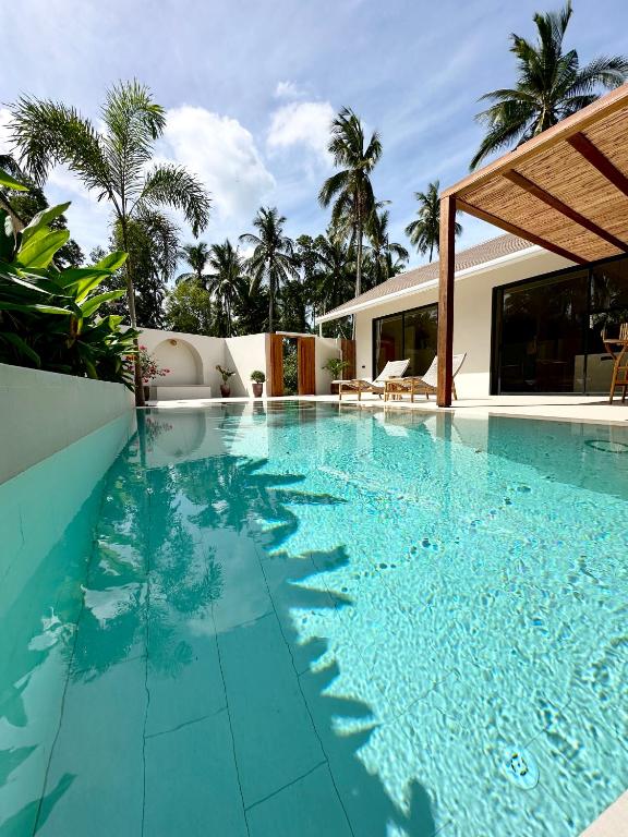 a swimming pool with blue water in a house at K Villas Phangan 01 in Thong Sala