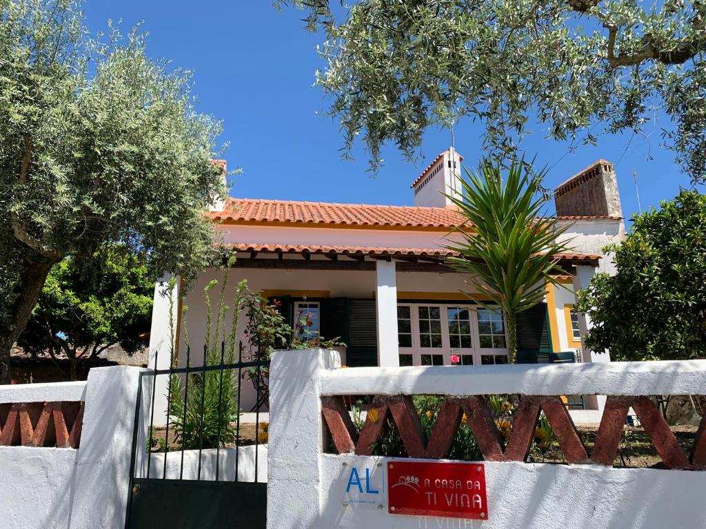 a house with a fence in front of it at A Casa da Ti Vina in Gavião