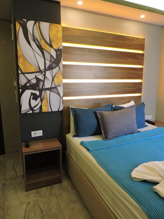 a bedroom with a bed with a wooden headboard at Başar hotel in Erdemli