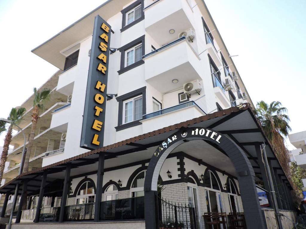 a hotel with a sign on the front of it at Başar hotel in Erdemli