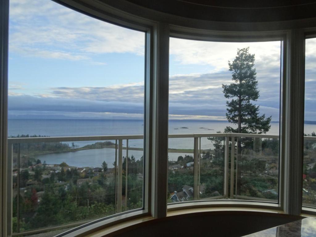 a room with a large window looking out at the water at Gibralter Rock Ocean View B&B in Nanaimo