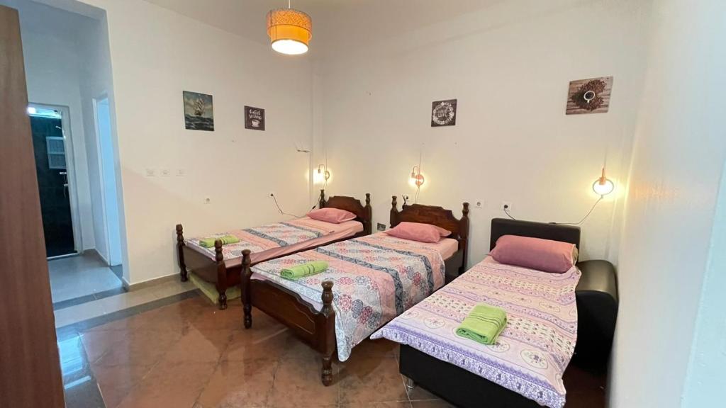a bedroom with two beds and a hallway at Hostel Flash in Ulcinj