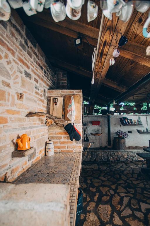 a room with a brick wall and a bench at Villa SHU in Krimovice