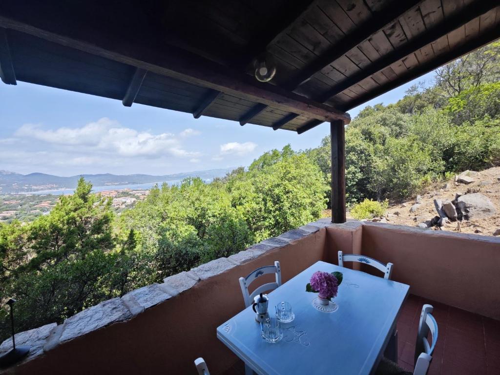 a white table with flowers on top of a balcony at Vista Smeralda in Porto Rotondo