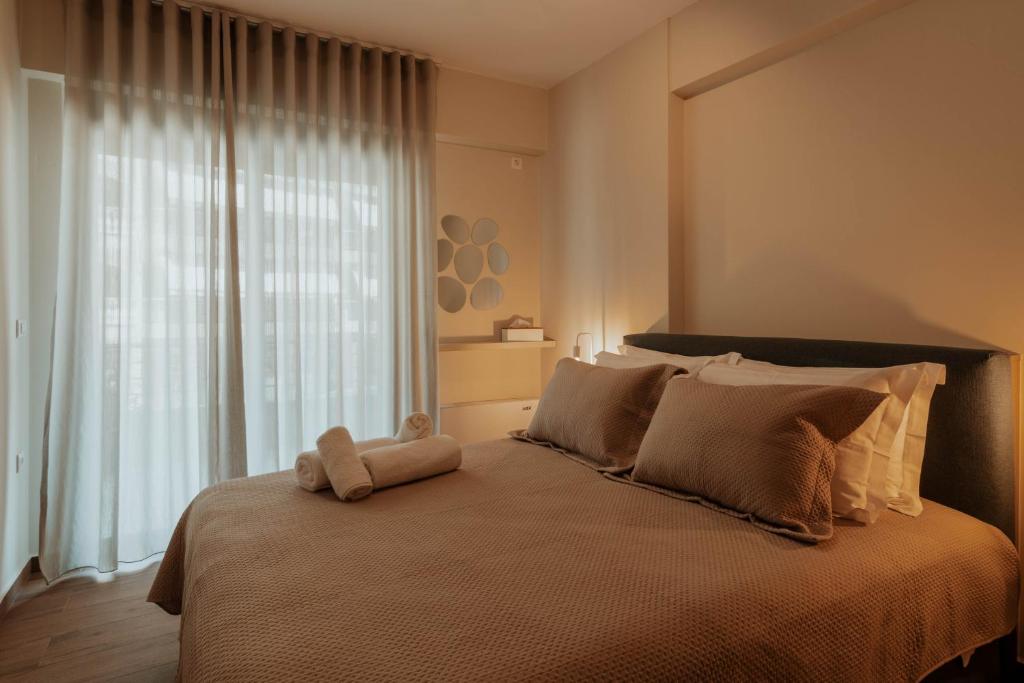 a bedroom with a bed with a teddy bear on it at Dantis Place Alpha1 in Nafplio