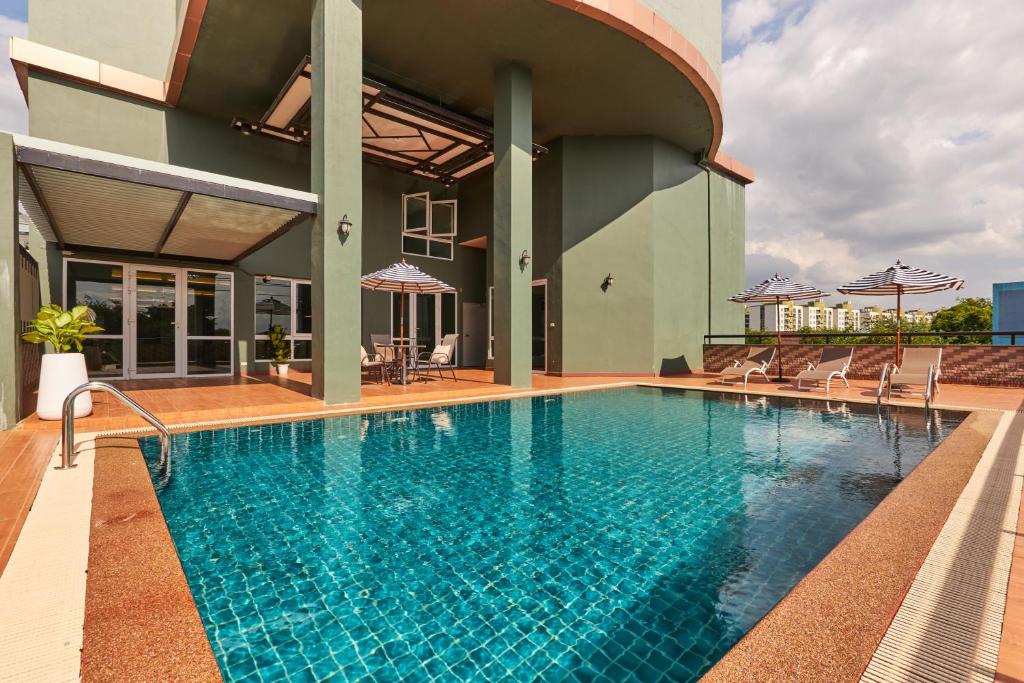 A rooftop pool beside a covered building terrace.