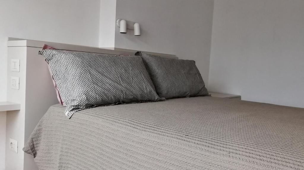 a bed with two pillows on top of it at Cà da moae 1 in Chiavari