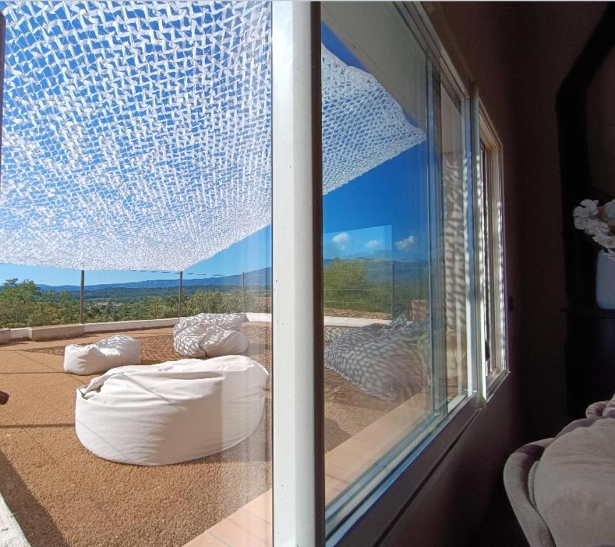 a room with a window with a view of the mountains at Là où le Ciel est né Beau mas pierres et contemporain sur grande propriété vue Mont Ventoux dentelles de Montmirail in Blauvac