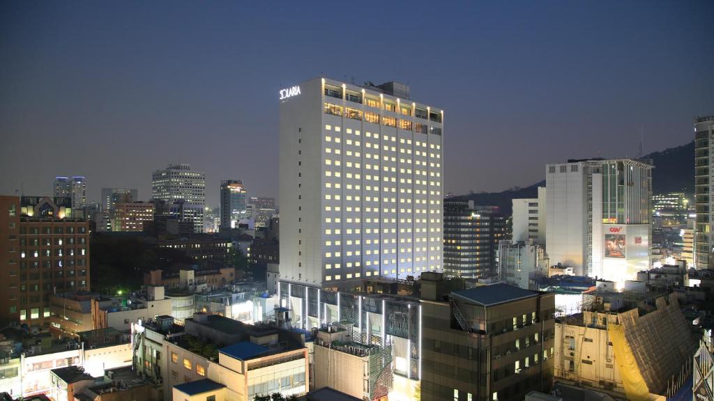 a lit up building in a city at night at Solaria Nishitetsu Hotel Seoul Myeongdong in Seoul