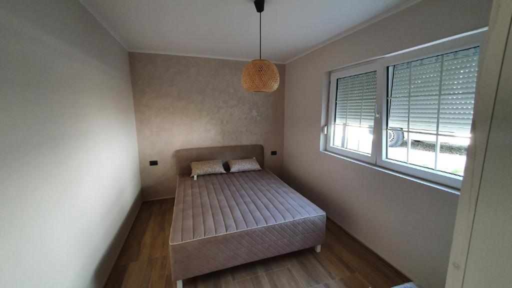 Postel nebo postele na pokoji v ubytování Apartmani Drinske ploce