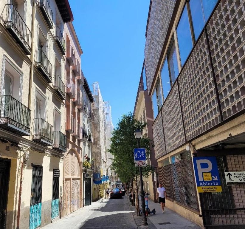 una via cittadina con edifici e persone che camminano per strada di MIMA Suites Chueca a Madrid
