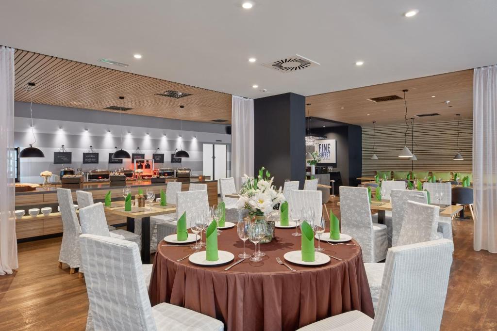 a dining room with a table and white chairs at Spa Hotel Felicitas in Poděbrady