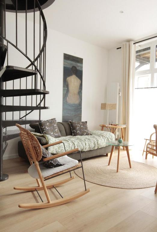 a living room with a couch and a chair at Ti Melen in Morlaix