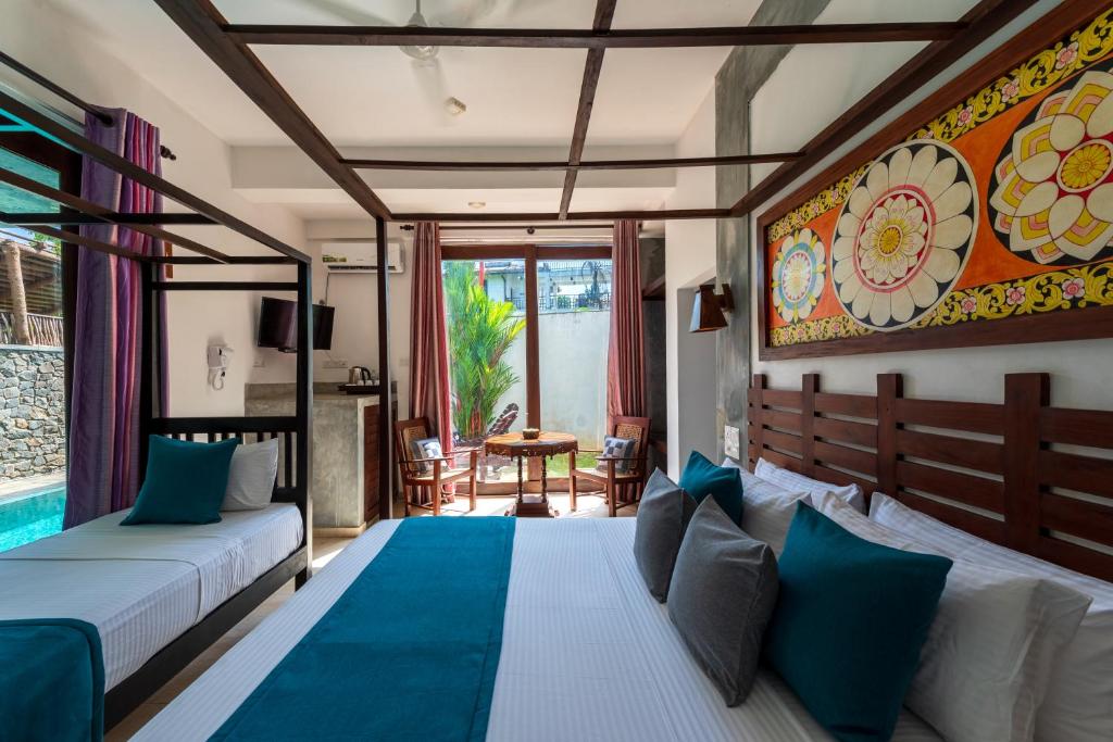 a bedroom with a bed and a pool at Anama by Queens Mount in Tangalle