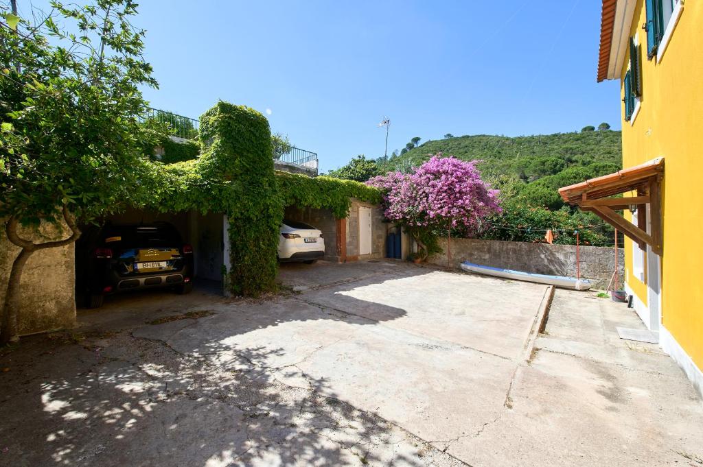 a house with a car parked in a driveway at Beach & Nature Villa with Amazing Pool by TimeCooler in Setúbal