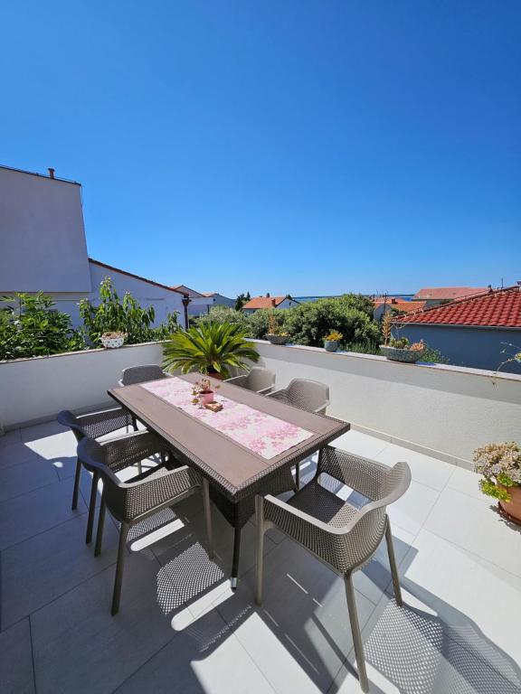 a table and chairs on a balcony with a view at Summer in Mandre in Mandre