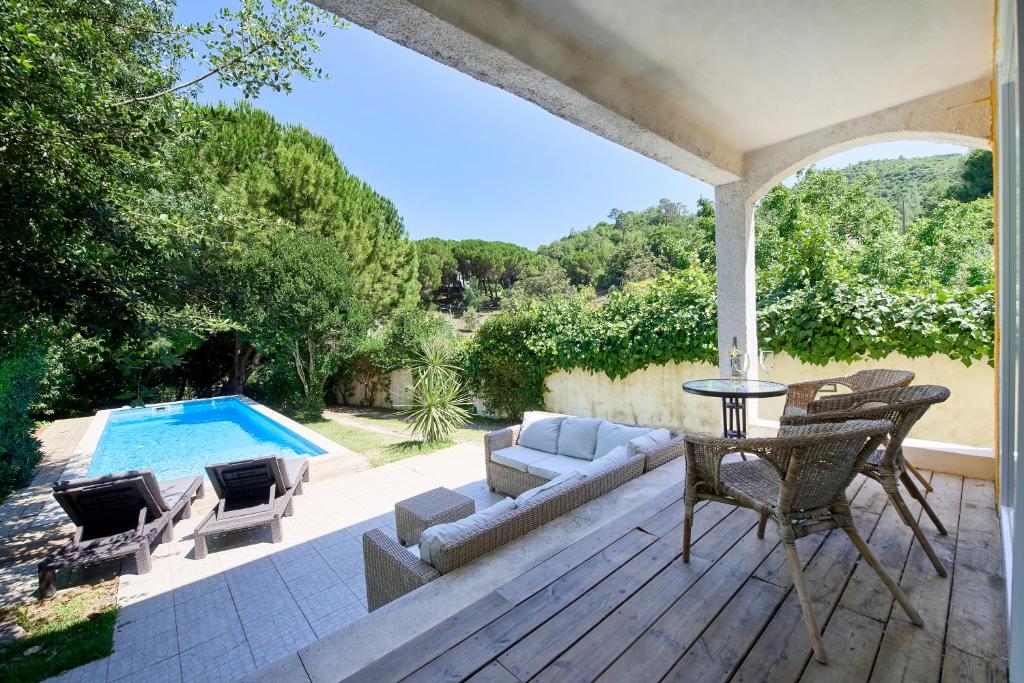 a patio with a pool and a table and chairs at Beach & Nature Villa with Amazing Pool by TimeCooler in Setúbal