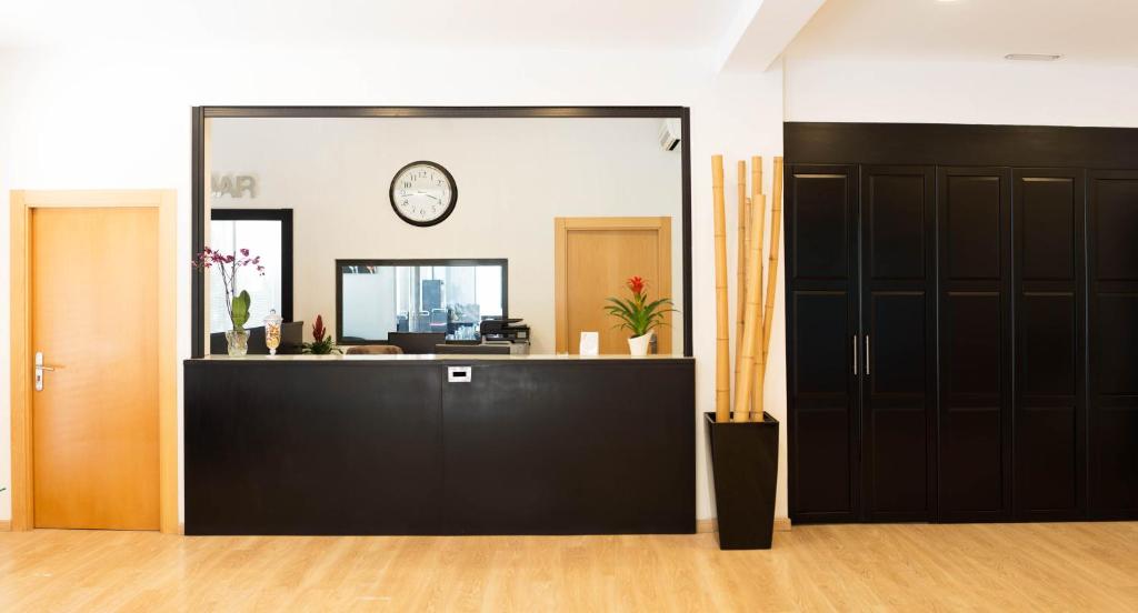 an office with a large mirror in a room at Hotel Cim Valles in Santa Perpetua de Moguda