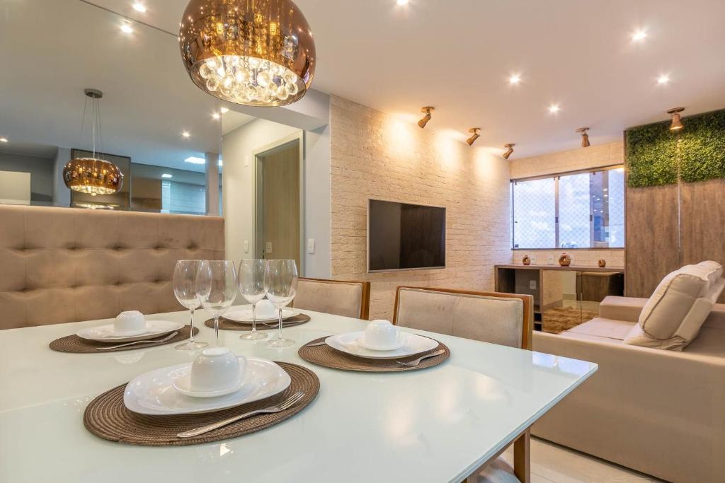 a dining room with a white table and chairs at APTO 2 quartos com lazer e vaga in Brasilia