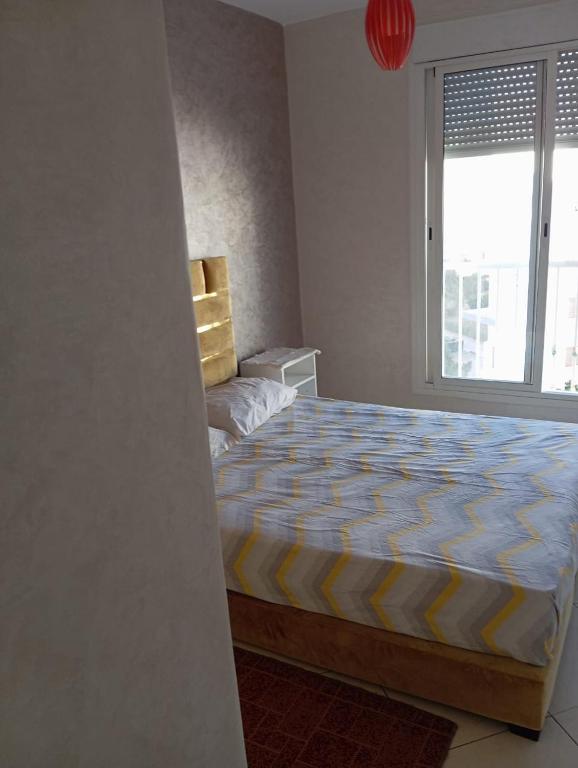 a bedroom with a large bed and a window at Hay mohamady islane in Agadir