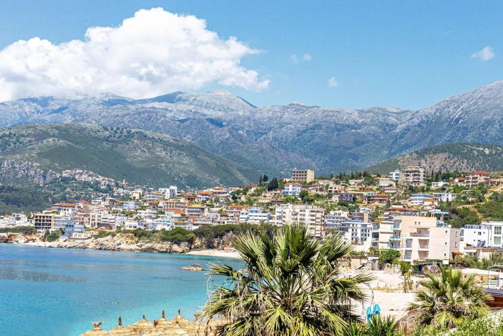 eine Stadt am Ufer eines Wasserkörpers in der Unterkunft Potam'Sea Bliss 8 - Beach Front, Sun Beds & Parking in Himarë