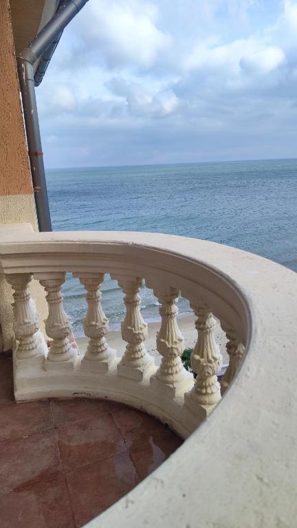 a white railing on a balcony overlooking the ocean at Elenite Sea View Apartments in Elenite