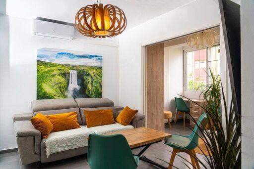 a living room with a couch and a table at Céntrico y luminoso in Huelva