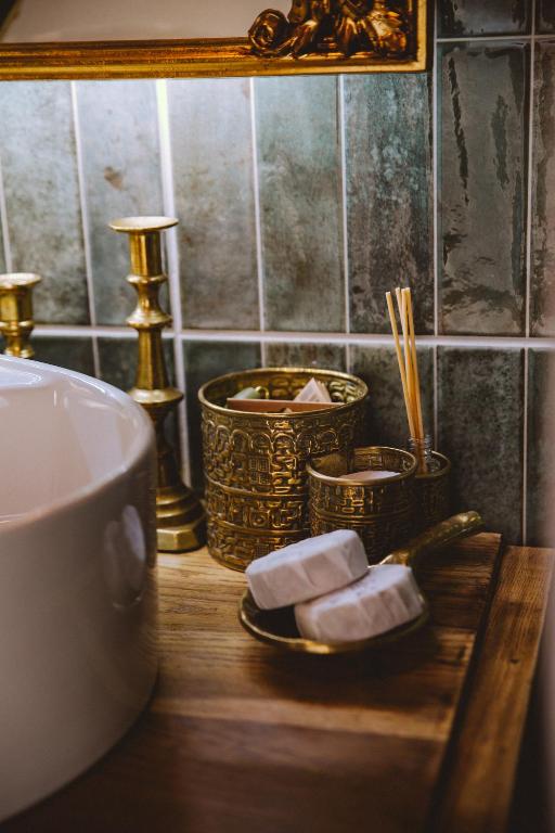 a bathroom counter with two baskets of soap and chopsticks at Old Believers Apartment in Rēzekne