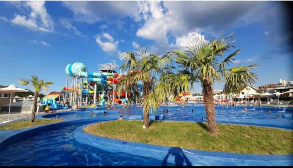 a large pool with a water park with a water slide at Nektar 88 in Vrnjačka Banja