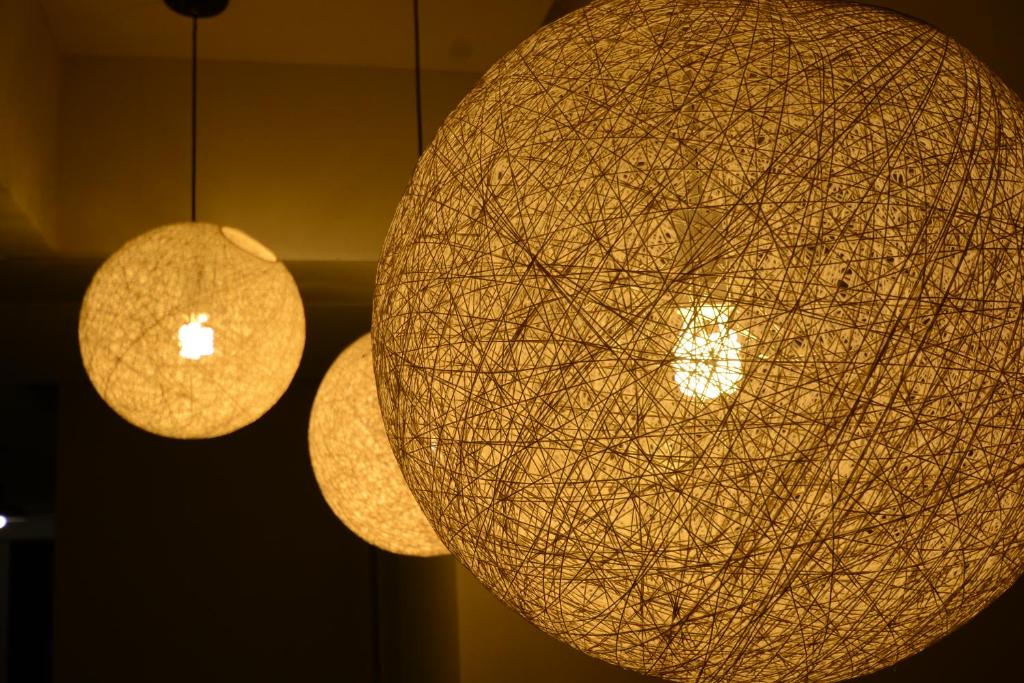 two orb lights hanging from the ceiling of a room at Travel Art Inn in Chiayi City