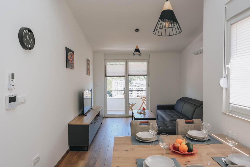 a living room with a couch and a table at Toplish 3 relax in Budva