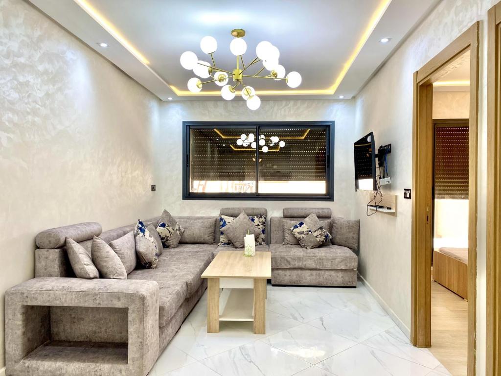 a living room with a couch and a table at appartment igar azougagh elhoceima in Al Hoceïma