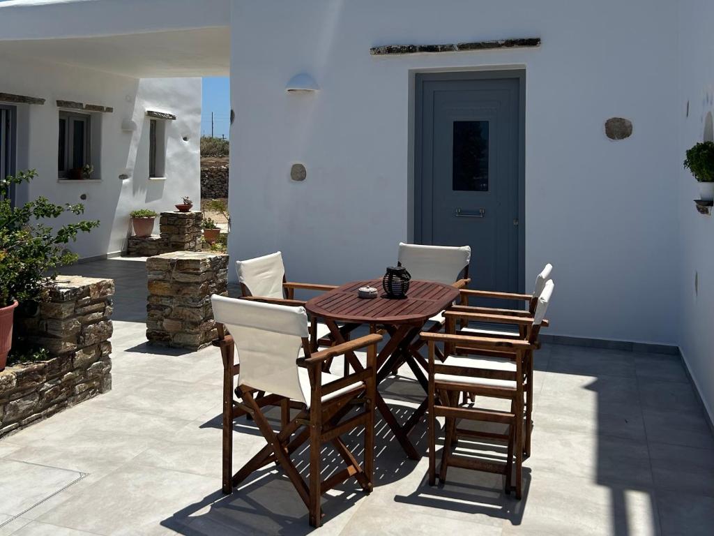 a wooden table and chairs on a patio at Antiparos Diamond in Antiparos Town