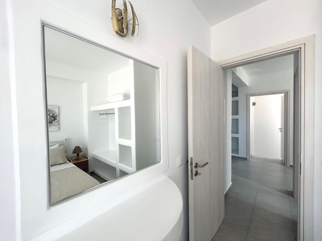a bathroom with a large mirror on the wall at Antiparos Diamond in Antiparos Town