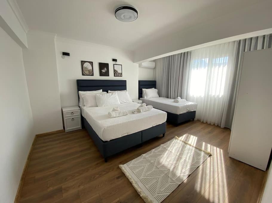 a large bedroom with two beds and a window at Villa Deja Blue in Karaburun